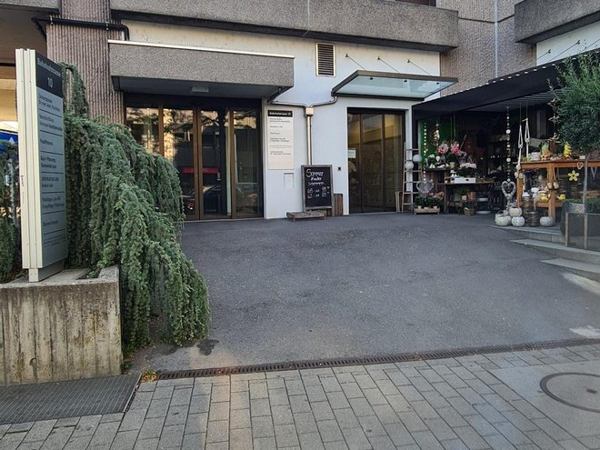 Der Hauseingang an der Bahnhofstrasse 10 mit Beschriftungstafel und Blumengeschäft daneben